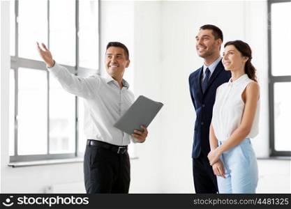 real estate business, sale and people concept - happy smiling realtor with folder showing customers new office room. realtor with folder showing customers new office. realtor with folder showing customers new office