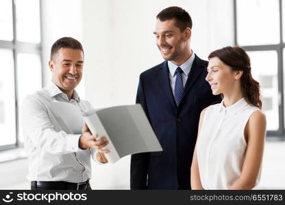 real estate business, sale and people concept - happy smiling realtor with folder showing documents to customers at new office room. realtor with folder showing documents to customers. realtor with folder showing documents to customers