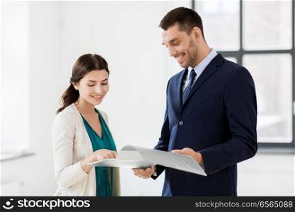 real estate business, sale and people concept - happy smiling realtor with folder showing documents to female customer at new office room. realtor with folder showing documents to customer