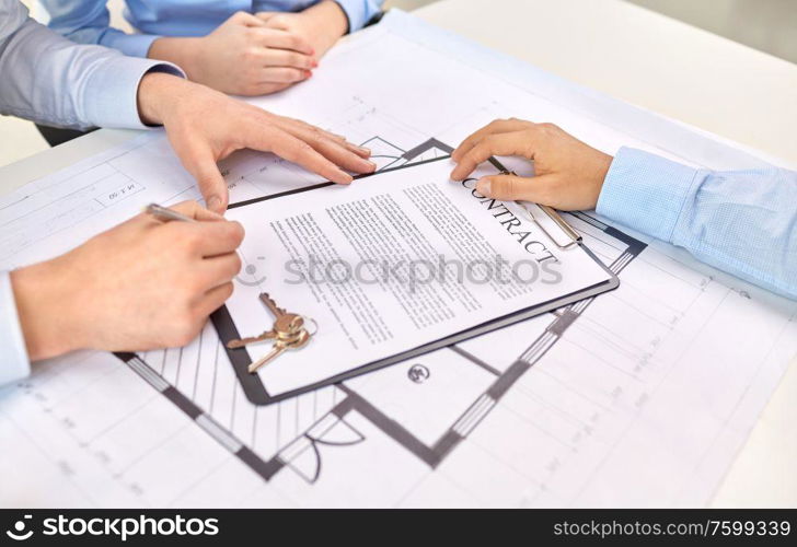 real estate business, sale and people concept - male realtor&rsquo;s hands and customers signing property purchase contract at office. hands signing property purchase contract at office
