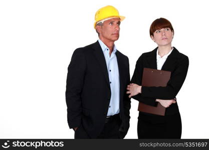 real estate businessman and assistant looking at something