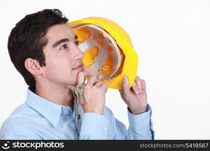 real estate businessman holding keys and helmet