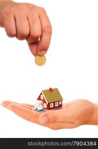 Real estate concept. Hand with coin and house.