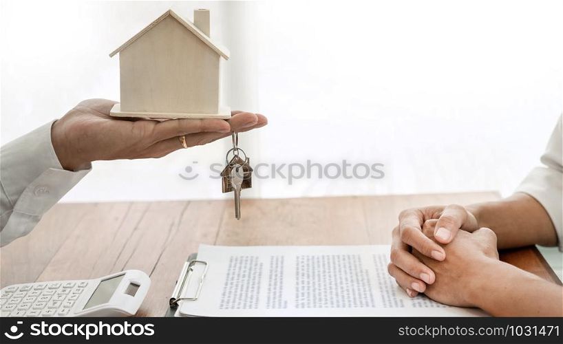 Real Estate developer Agent and sign on document giving keys of new house, Property agent giving offer to buyer