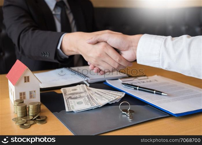 Real Estate developer Agent and sign on document giving keys of new house, Property agent giving offer to buyer