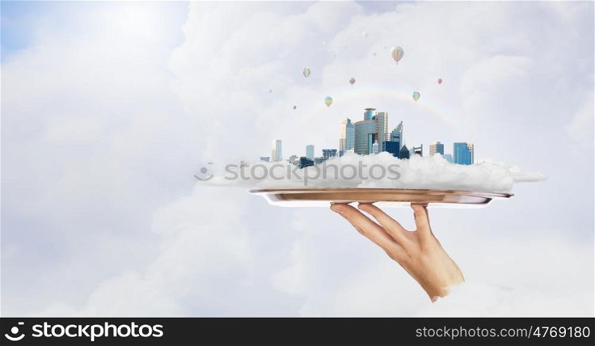 Real estate exhibition. Hand holding metal tray with real estate concept
