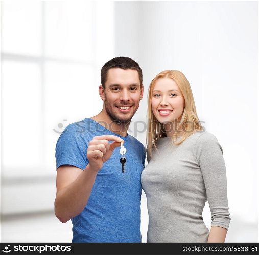 real estate, family and couple concept - smiling couple holding keys