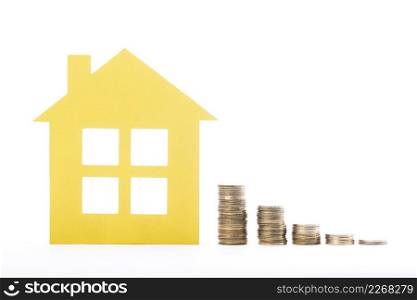 real estate house piles coins white background
