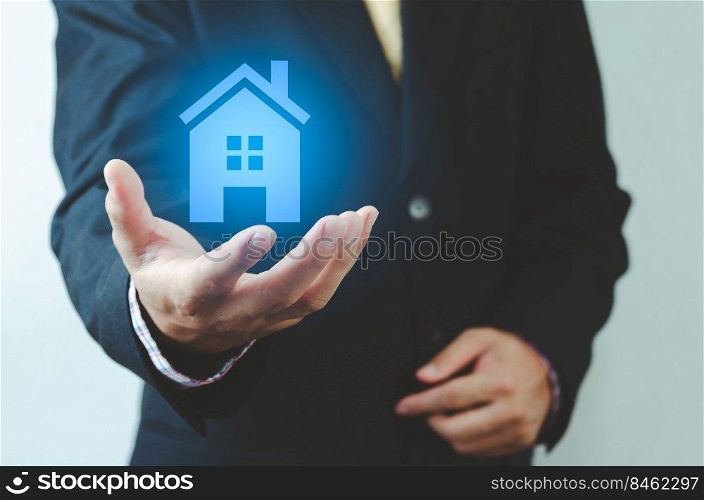 real estate ideas house trading Businessman holding house icon. House on hand. Insurance and safety concept. Symbol of house.