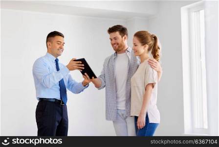 real estate, mortgage, technology and people concept - happy couple and realtor with tablet pc computer at new home. couple and realtor with tablet pc at new home