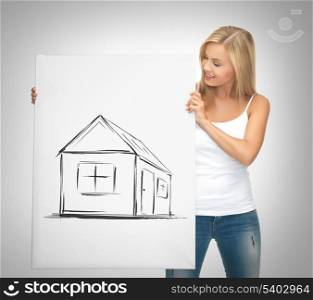 real estate, property, business and accomodation concept - woman holding picture with house
