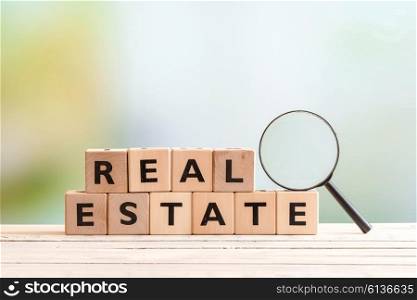 Real estate search sign with a magnifying glass on a table