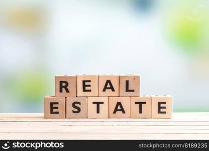 Real estate sign made of blocks on a wooden table