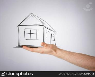 real estate, technology and accomodation concept - picture of house on virtual screen in man hand