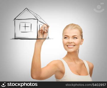 real estate, technology and accomodation concept - woman drawing house on virtual screen