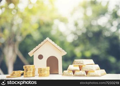 Real estate valuation Saving Money Concept. Woman hand go down on budget to buy house real estate agent. Gold coins stack symbol buy house