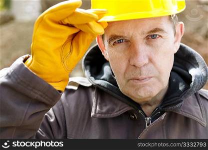 real experienced builder with yellow hardhat, natural light
