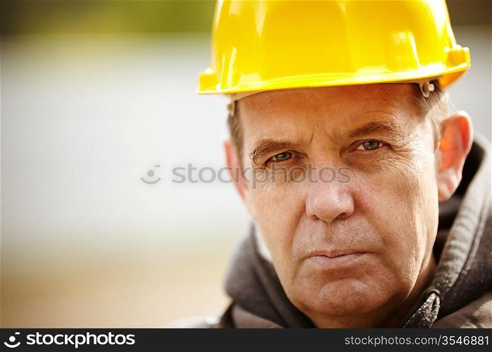 Real experienced builder with yellow hardhat, natural light