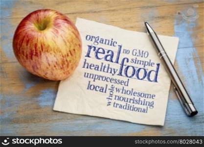 real food word cloud on a napkin with a fresh apple - healthy lifestyle concept