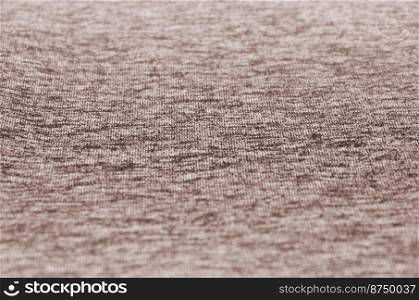 Real heather knitted fabric made of synthetic fibres textured background. Colored fabric texture. Background with delicate striped pattern