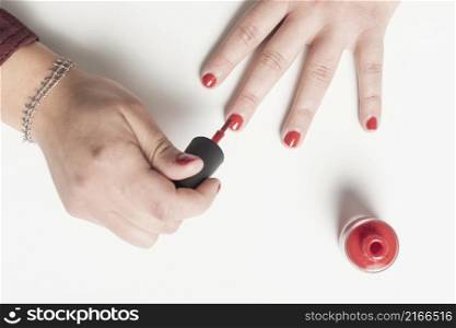 Real lady panting her nails in red color