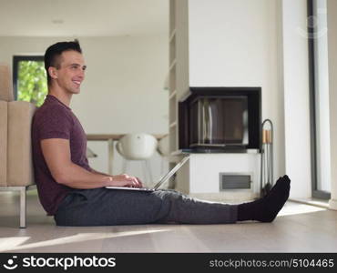 Real man Using laptop on the floor At Home Enjoying Relaxing