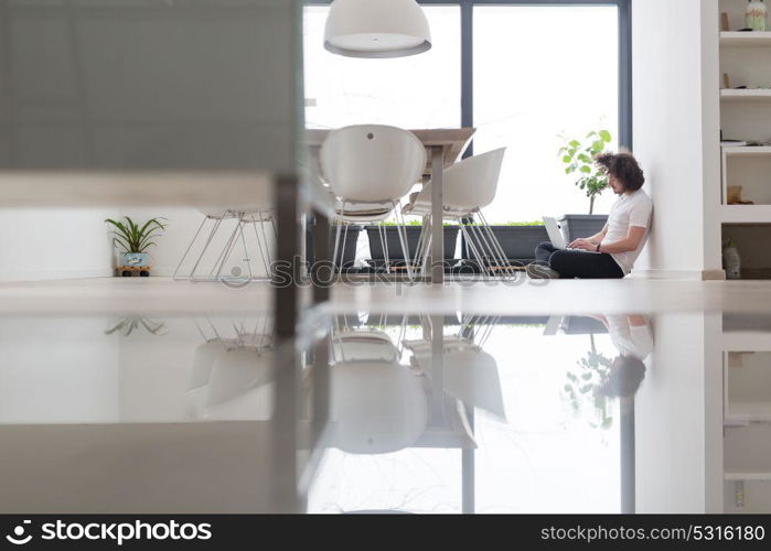 Real man Using laptop on the floor At Home Enjoying Relaxing