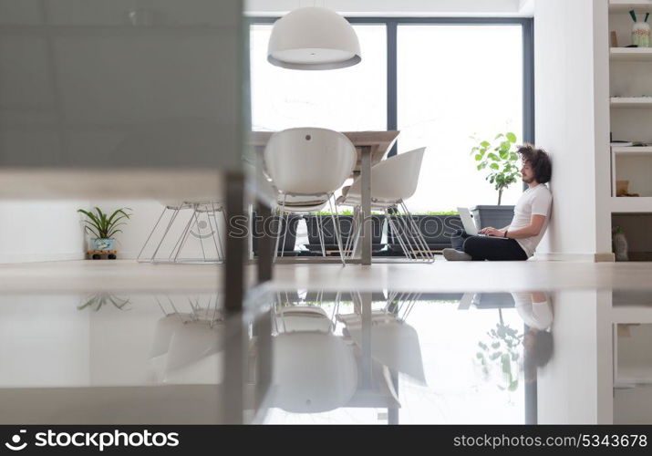 Real man Using laptop on the floor At Home Enjoying Relaxing