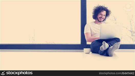 Real man Using laptop on the floor At Home Enjoying Relaxing