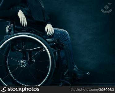 Real people, disability and handicap concept. Young woman invalid girl sitting on wheelchair part of body studio shot on black