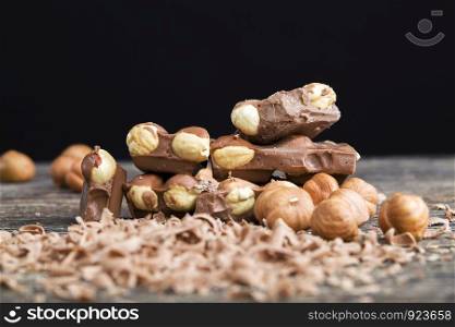 real quality milk chocolate with roasted hazelnut kernel, close-up of cocoa sweets. real quality milk chocolate