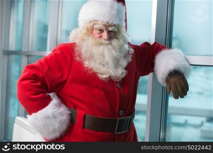 Real Santa Claus standing at airport and waiting for his flight