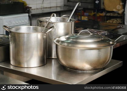 real used restaurant kitchen, three pots, selective focus. real kitchen