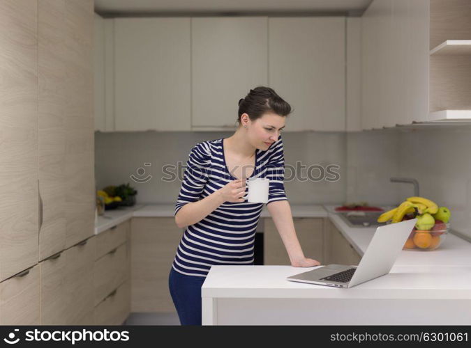 Real Woman Using laptop At Home Drinking Coffee Enjoying Relaxing