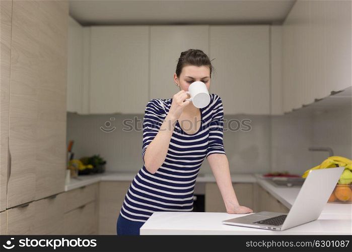 Real Woman Using laptop At Home Drinking Coffee Enjoying Relaxing