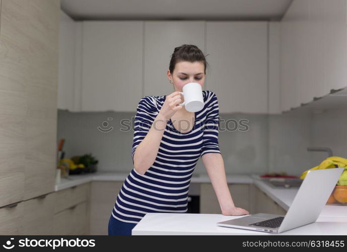 Real Woman Using laptop At Home Drinking Coffee Enjoying Relaxing