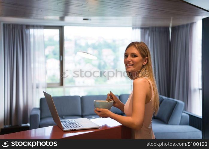 Real Woman Using laptop At Home eating breakfast Enjoying Relaxing