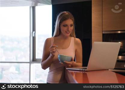 Real Woman Using laptop At Home eating breakfast Enjoying Relaxing