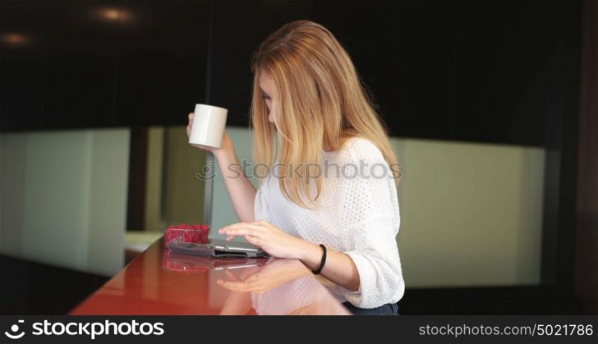 Real Woman Using Mobile Phone At Home Drinking Coffee Enjoying Relaxing