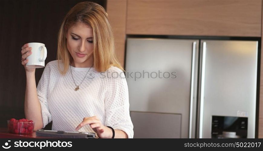 Real Woman Using Mobile Phone At Home Drinking Coffee Enjoying Relaxing