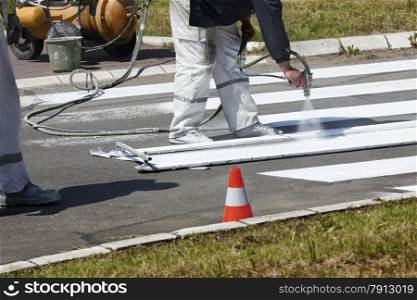 Real Workers Renew the Road Marking on the Street