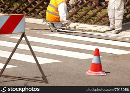 Real Workers Renew the Road Marking on the Street