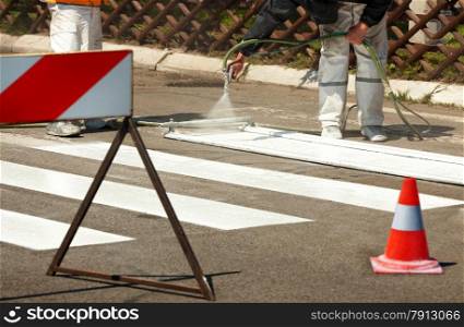 Real Workers Renew the Road Marking on the Street