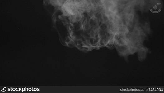 Realistic smoke of vapor steam cloud motion on a black background for using in composition. 4K UHD video 3840, 2160p.. Video of moving white smoke or vapor on a black background.
