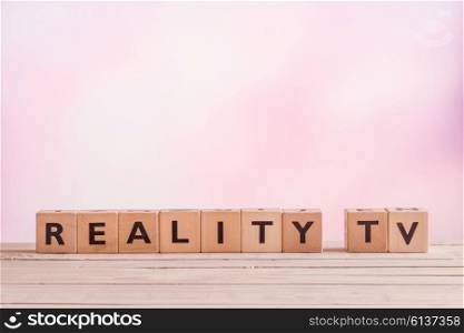 Reality TV sign made of wood on a violet background