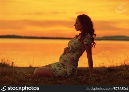 Realxed lady looking at the sunset