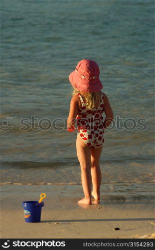 Rear of a young girl (6-8) on a beach, Moorea, Tahiti, French Polynesia, South Pacific