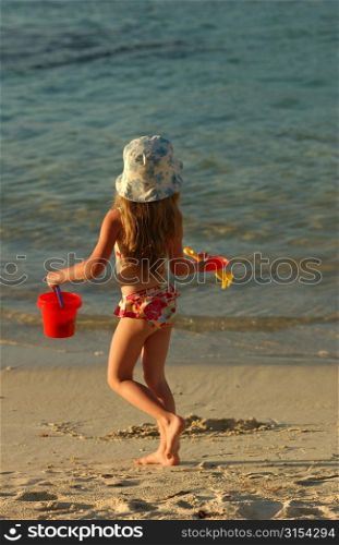 Rear of a young girl (6-8) on a beach, Moorea, Tahiti, French Polynesia, South Pacific