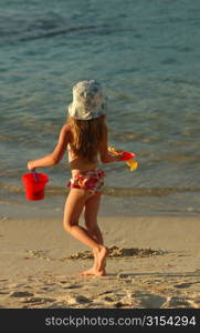 Rear of a young girl (6-8) on a beach, Moorea, Tahiti, French Polynesia, South Pacific