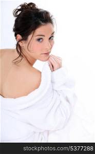 Rear shot of woman removing bathing robe